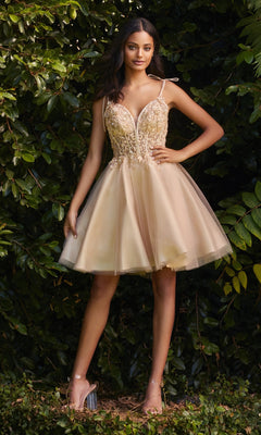 A woman stands outdoors before green foliage, wearing the Glitter-Tulle Short A-Line Prom Dress CD0188, featuring a fitted bodice and flared glitter tulle skirt, paired with clear high-heeled shoes.