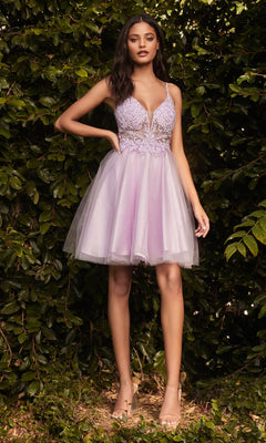 A woman stands outdoors before lush greenery, wearing the Lace-Bodice Short A-Line Homecoming Dress CD0190 with a sheer-lace bodice, lace detailing, and nude high-heeled sandals.