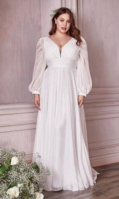 A woman stands indoors in a Long White Chiffon Formal Dress with Long Sleeves, under $200, paired with floral hair accessories beside a bouquet of white flowers.