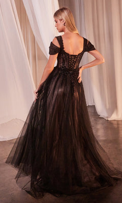 A woman stands on a concrete floor surrounded by white draped curtains, wearing the Lace-Up Long Black Prom Dress: Ladivine CD0237.