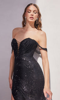 A woman wearing the Draped Off-Shoulder Long Sequin Prom Dress CD290, a strapless black gown with thin off-the-shoulder straps, stands against a light background.