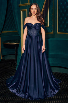 A woman stands in an elegant room wearing the Ladivine CD297, a strapless long A-line prom dress in navy blue with a structured bodice and draped skirt.