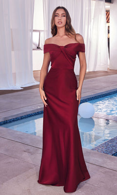 A woman stands by a pool wearing the Off-the-Shoulder Long Prom Dress with Train CD325 in burgundy, featuring a floor-length fitted silhouette. White curtains and a building in the background enhance the elegance of her look.