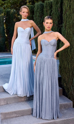 Two women stand outdoors by a pool, both wearing the Ladivine CD414 long prom dress in light blue chiffon with a-line skirts and matching neck scarves, trees visible in the background.