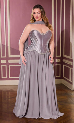 A woman stands in an elegant room wearing the Long Plus-Size Prom Dress Ladivine CD668C in dark silver, featuring a strapless corset bodice, flowing chiffon skirt, and a matching neck scarf.