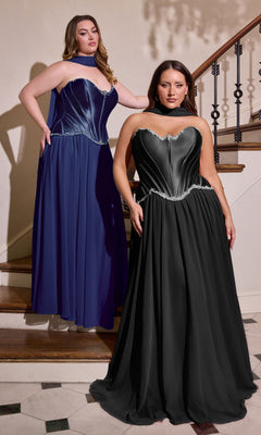 Two women stand on a staircase, each wearing the Long Plus-Size Prom Dress: Ladivine CD668C in navy. The strapless gown features a metallic corset bodice and flowing chiffon skirt, making it a stunning plus size prom dress option.