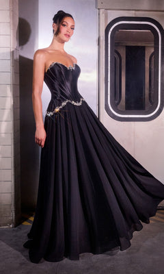 Model wears the Ladivine CD668 Long Prom Dress in black, featuring a satin corset bodice with jeweled accents and an A-line chiffon skirt, standing beside a metallic train door in an industrial setting.