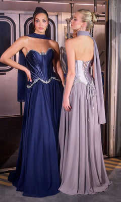 Two women stand side by side in a subway car, both dressed elegantly; one wears the Ladivine CD668 Long Prom Dress in navy, which features a flowing chiffon A-line skirt, while the other dons a strapless light gray gown with a lace-up back.
