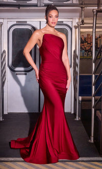 A woman in the Ladivine CD694 Asymmetrical Strapless Prom Gown poses confidently inside a subway train car, standing by the closed doors and metal poles.