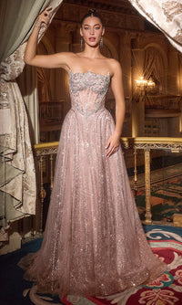 Woman in a sparkling mauve evening gown standing in an opulent room with chandeliers.