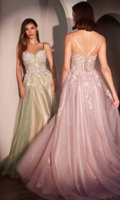 Two women showcase the Ladivine CD740, a long glitter-tulle prom dress with beaded floral appliques. One wears a green A-line style facing forward; the other, in pink, faces away revealing the gown’s chic lace-up back detail.