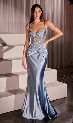 A woman poses in the Ladivine CD752 Sheer-Corset Long Satin Prom Dress, featuring a fitted beaded bodice with spaghetti straps, near white steps and sheer curtains.