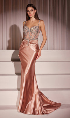 A woman stands on white steps in front of draped curtains wearing the Ladivine CD757 Crystal-Bodice Long Prom Dress, a floor-length rose gold satin gown with a fitted, crystal-beaded bodice.