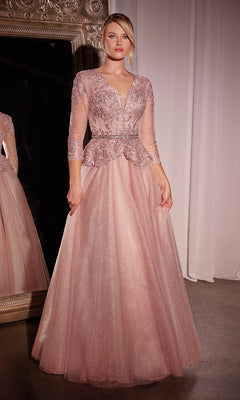 A woman poses gracefully indoors in the Ladivine CD789, a long dusty rose pink formal dress with sleeves, featuring a beaded bodice and tulle skirt, in front of a large ornate mirror.