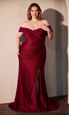 A woman poses indoors in the Off-Shoulder Plus-Size Prom Gown: Ladivine CD790C—a deep red, fitted evening gown with a thigh-high slit, under $150. She stands facing forward, one hand on her chest and the other holding her dress elegantly.