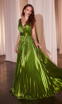 A woman wears the Ladivine CD802 long prom dress, featuring a metallic pleated A-line skirt, sleeveless V-neck bodice, wide waistband, and cape detail, standing before draped white curtains.