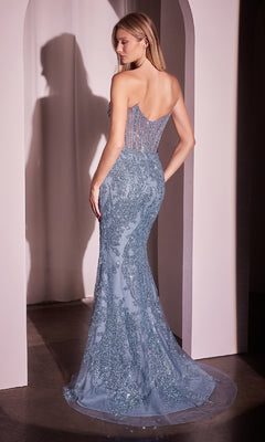 A woman wearing the Sparkly Beaded Strapless Prom Dress: Ladivine CD847 with intricate embroidery and a form-fitting silhouette stands in a softly lit archway.