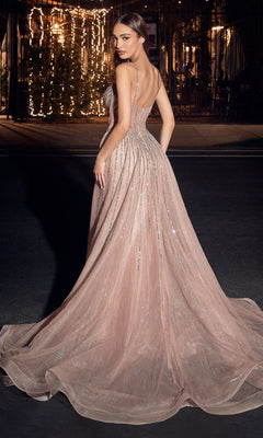 A woman poses outdoors at night in the Beaded Overskirt Long Formal Prom Dress CD863, a rose pink gown with silver embellishments and a train, looking over her shoulder.