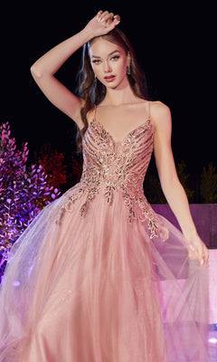 A woman stands outdoors at night in the Glitter-Bodice Long Prom Ball Gown CD874, a sleeveless blush pink dress featuring intricate beading and a flowing tulle skirt.
