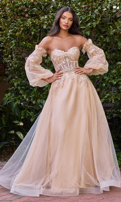 A woman stands outdoors in the Strapless Puff-Sleeve Long Prom Dress CD948, featuring a blush sweetheart neckline, sheer corset bodice with floral appliques, voluminous tulle skirt, and removable puff sleeves for a romantic look.