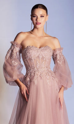 A woman wears the Strapless Puff-Sleeve Long Prom Dress CD948, featuring a blush pink sweetheart neckline, sheer removable puff sleeves, and detailed floral embroidery on the bodice.
