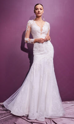A woman stands against a purple wall wearing the Long Sleeve Long White Wedding Dress CD951W—an elegant, lace-embellished gown with a fitted bodice and flowing skirt.
