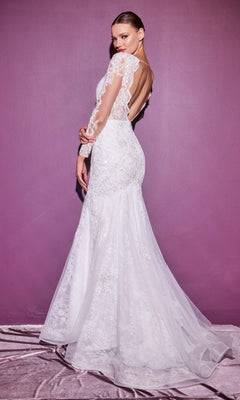 A woman in the Long Sleeve Long White Wedding Dress CD951W with lace, a mermaid silhouette, and open back stands against a purple wall, looking over her shoulder.