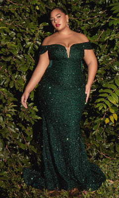 A woman in the Plus-Size Sequin Mermaid Prom Dress CD975C, an off-the-shoulder, sparkly dark green gown, stands before lush green foliage.