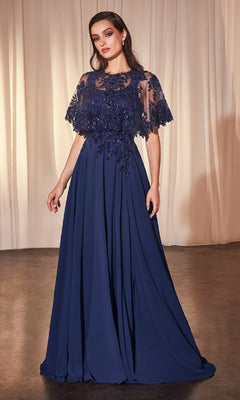 A woman stands before beige curtains wearing the Beaded-Cape Long Formal Dress (CLCDS503), featuring a navy blue A-line silhouette with lace, sequin bodice details, and sheer cape sleeves.