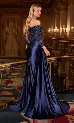 Woman in a blue evening gown standing in an opulent room with chandeliers.