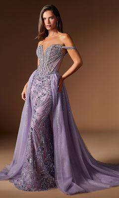 A woman wears the Ladivine CDS570 Long Prom Dress in English Violet, featuring strapless design, intricate beadwork, sheer panels, off-shoulder straps, and a flowing tulle overskirt—perfect for formal occasions.