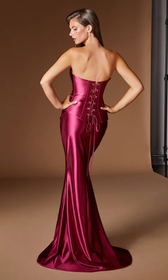 A woman stands facing away against a plain brown background, highlighting the sleek silhouette of the Ladivine CH2602 Long Prom Dress—a shiny, strapless magenta mermaid gown featuring a lace-up corset back.