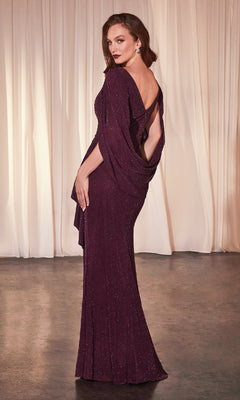 A woman wearing the Ladivine CH386 Wine Red Long Wedding-Guest Dress with an open back stands on a concrete floor before cream-colored drapes, glancing over her shoulder.