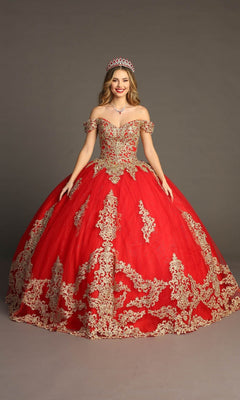 A woman wearing the Quinceanera Dress CHF3043 By Chicas in Red/Gold, with gold embroidery and a tiara, stands against a plain gray background, smiling at the camera.