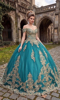 A woman in the Quinceanera Dress CHF3043 by Chicas, featuring an off-the-shoulder design with gold embroidery in a striking teal green/gold color, stands on a cobblestone path before an old stone building with arches. The shimmering ball gown’s delicate details create a stunning and elegant scene.