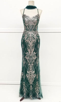 A mannequin displays the Chicas CHF3053 Lace-Up Long Glitter Prom Dress, a floor-length, sleeveless gown with thin straps and intricate silver patterns.