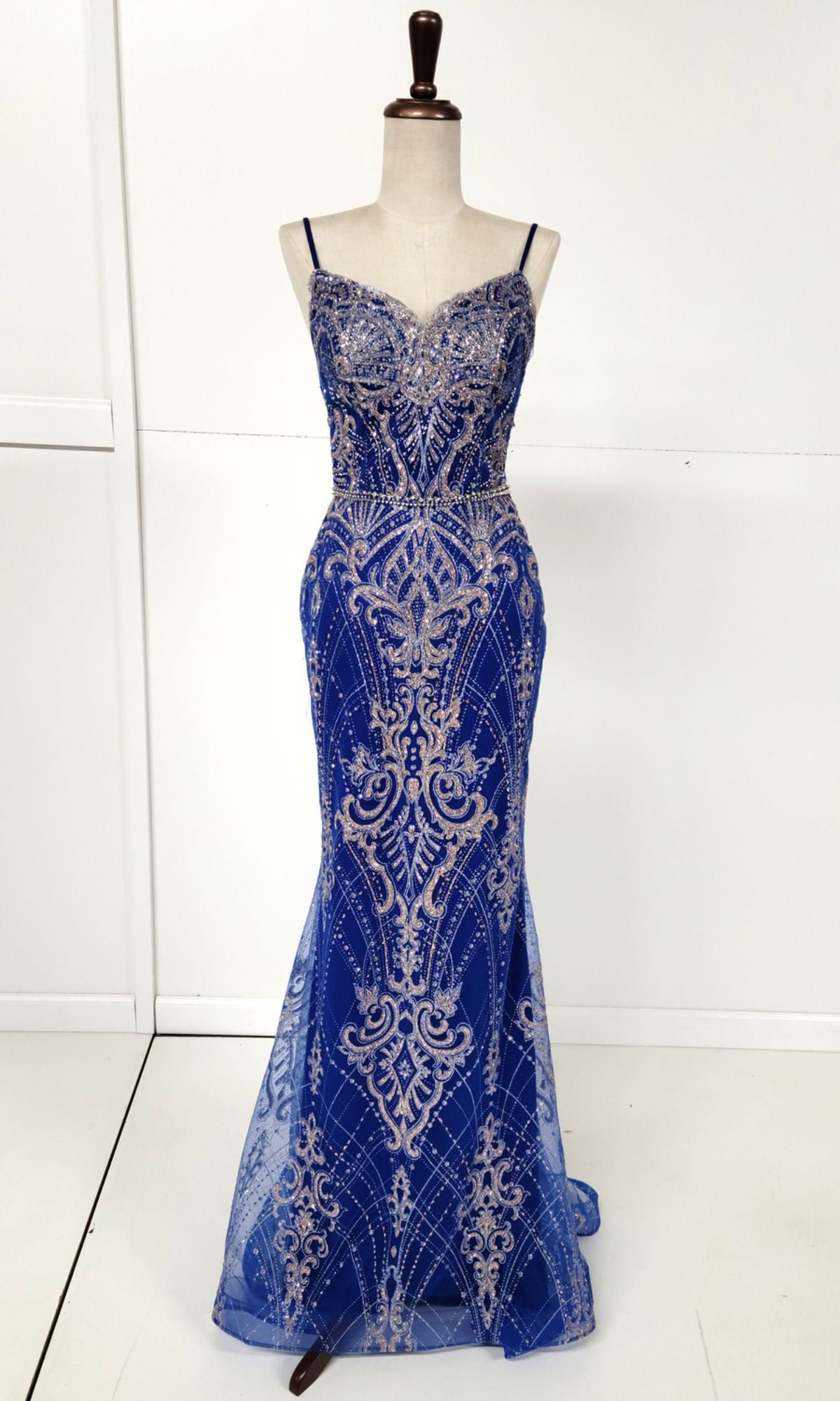 The Lace-Up Long Glitter Prom Dress: Chicas CHF3053 is a royal blue sequin evening gown with silver embroidery, fitted bodice, thin straps, and a floor-length hem, shown on a dress form against a plain white background.