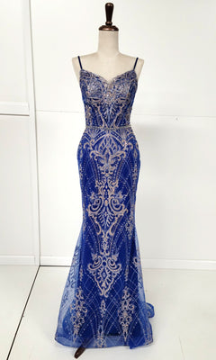 The Lace-Up Long Glitter Prom Dress: Chicas CHF3053 is a royal blue sequin evening gown with silver embroidery, fitted bodice, thin straps, and a floor-length hem, shown on a dress form against a plain white background.