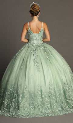 A woman stands on a gray background, facing away to showcase the fitted bodice, lace-up back, and full skirt of the Quinceanera Dress CHF3077 by Chicas. The green ball gown features floral and butterfly appliques, and her hair is styled up with a tiara.