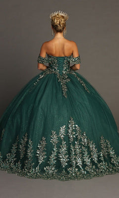 A woman is standing with her back to the camera against a plain gray background, wearing the Quinceanera Dress CHF3081 By Chicas—a dark green ballgown adorned with gold floral embroidery and styled with a gold crown.