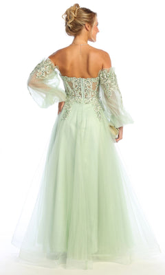 A woman in the Chicas CHF3093 long sleeve A-line prom dress with lace-up back stands facing away, wearing a light green sheer embroidered off-the-shoulder gown against a white background.