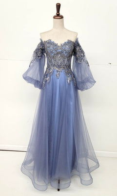 The Long Sleeve Long A-Line Prom Dress: Chicas CHF3093 features sheer bell sleeves, embroidered floral bodice details, and a flowing blue tulle skirt, displayed on a dress form against a plain background.