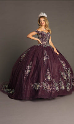 A woman wearing the Quinceanera Dress CHF3099 by Chicas, a purple off-the-shoulder ballgown skirt with floral embroidery, paired with a silver tiara and standing against a plain gray background.