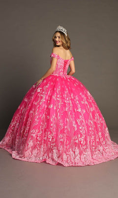 A woman stands and smiles against a plain backdrop, wearing the Quinceanera Dress CHF3100 By Chicas—a bright pink off-the-shoulder gown adorned with white floral patterns—and a tiara.