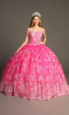 A woman wearing the Quinceanera Dress CHF3100 By Chicas—an off-the-shoulder pink tulle ballgown with white floral patterns—stands against a plain backdrop, smiling and accessorized with a jeweled tiara.