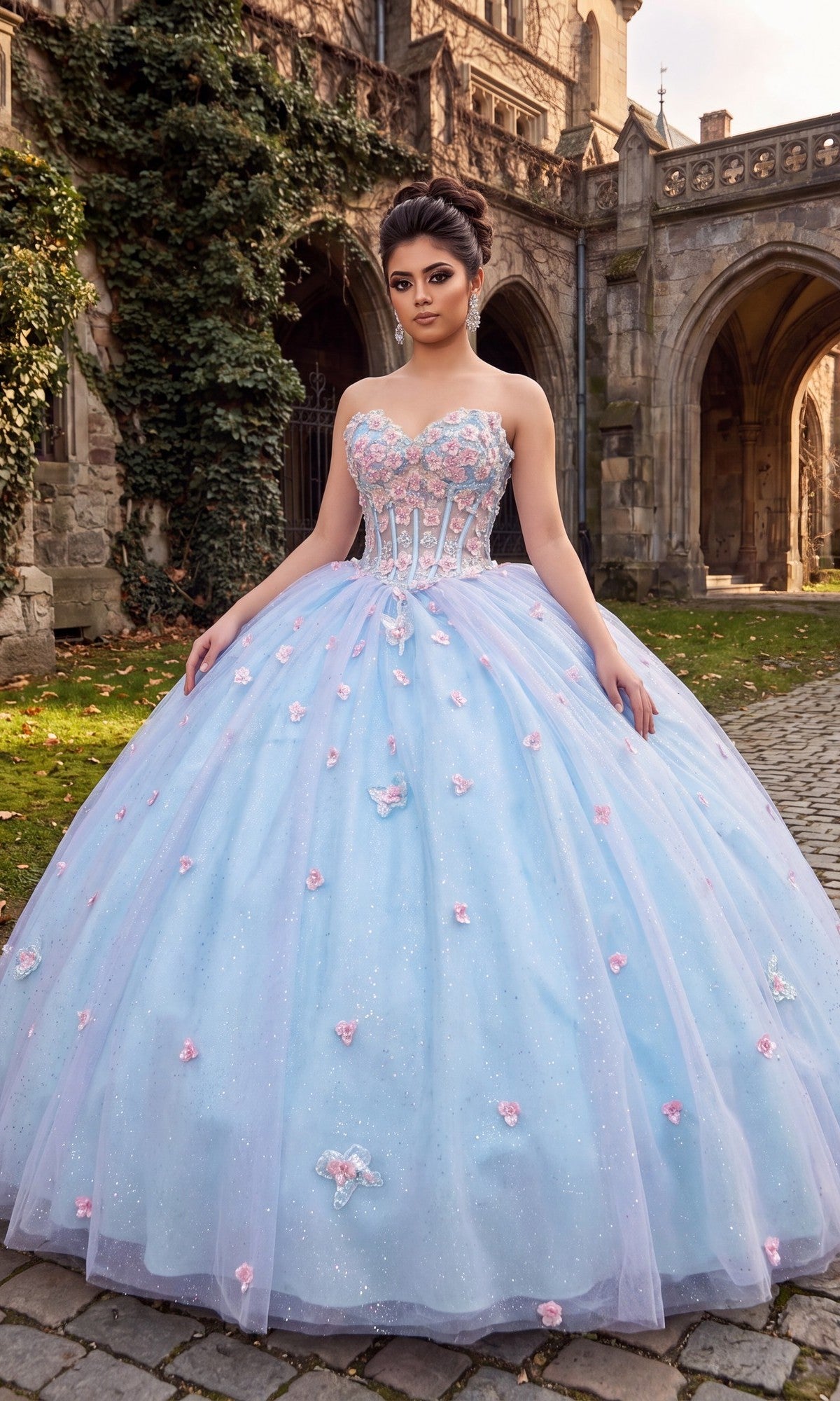 Wearing the Quinceanera Dress CHF3119 By Chicas in Baby Blue/Lilac, a woman stands on a cobblestone path outside a Gothic-style stone building.