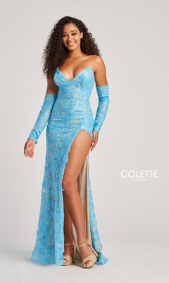 A woman smiles against a plain background, wearing the Colette Strapless Prom Dress with Gloves CL5107—a light blue, strapless gown featuring a high slit and matching gloves that showcase Colette by Daphne’s signature elegance.