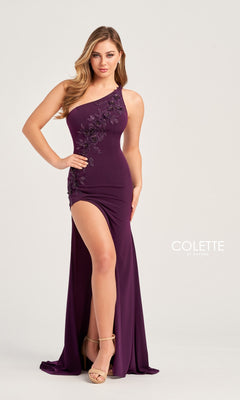 A woman models the Colette One-Shoulder Sleek Long Prom Dress CL5108, a floor-length purple gown with floral appliqué and a high slit, standing against a plain background.