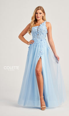 A woman wears the Colette One-Shoulder Designer Prom Dress CL5124 in light blue, featuring floral embroidery, a sheer tulle skirt, and a high leg slit, standing against a plain background.