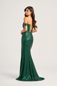 A woman stands looking over her shoulder in the Colette Off-Shoulder Long Sequin Prom Dress CL5129, a floor-length gown featuring shimmering sequins and a striking corset back detail.